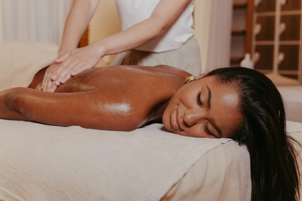A masseuse giving relaxing massage to a women.