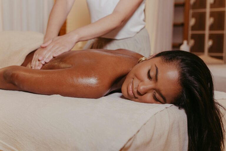 A masseuse giving relaxing massage to a women.