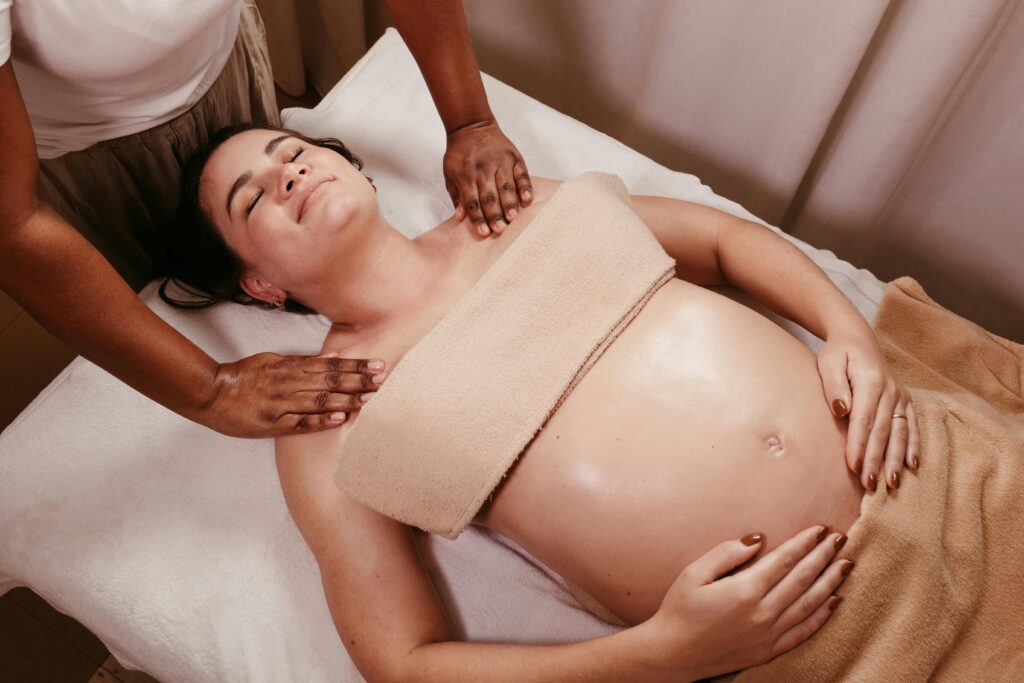 A masseuse giving massage to a pregnant women.